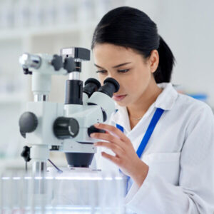 Laboratory Pathologist looking at a microscope.